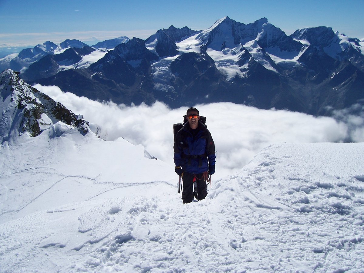 100_0773.JPG - Die letzten Schritte zum Bishorngipfel. Unter den Wolken liegt Täsch im Mattertal und dahinter das nächste Ziel der Dom mit seinen Nachbarn.